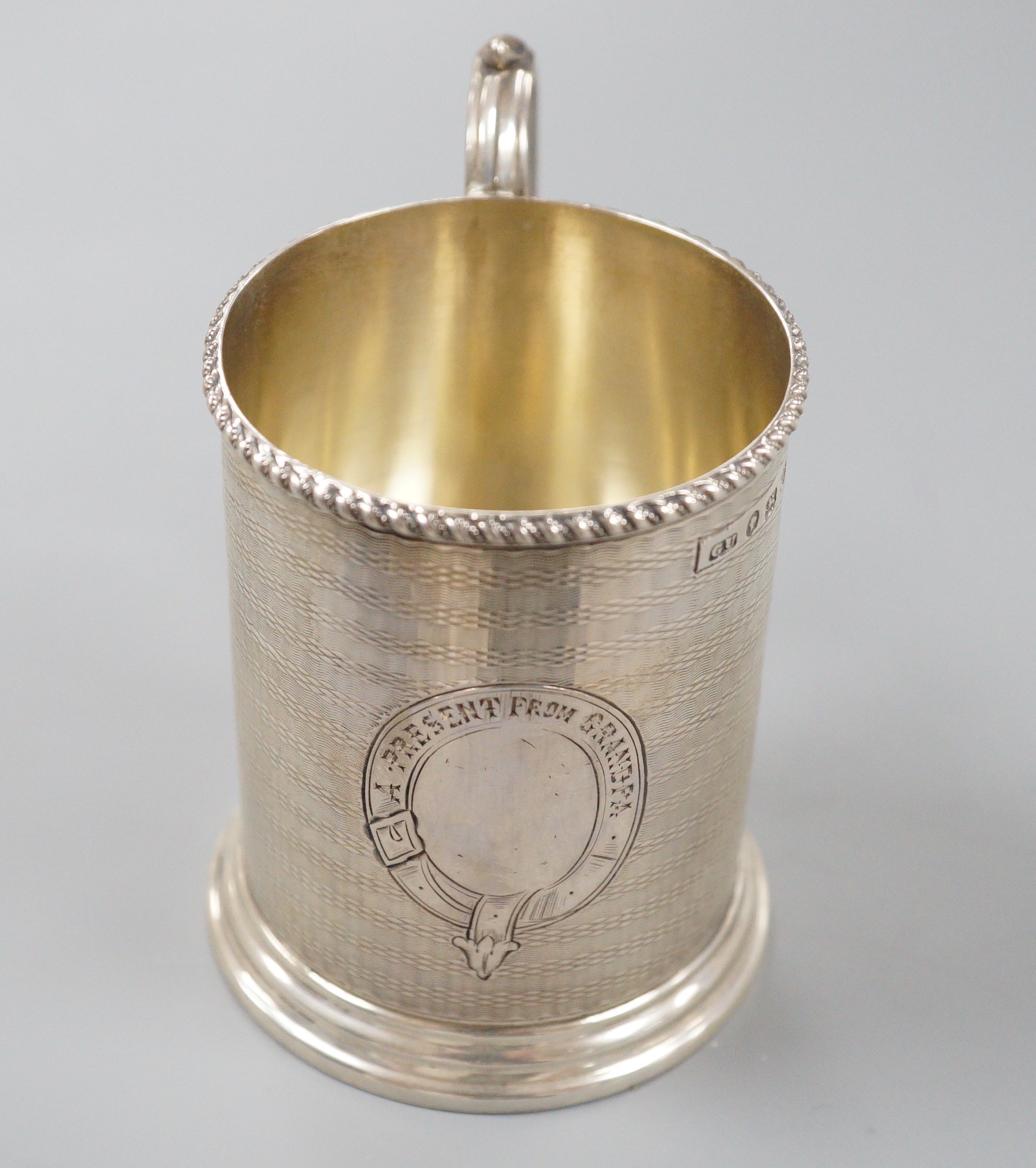 A Victorian engine turned silver christening mug, with engraved inscription, George Unite, Birmingham, 1868, 86mm.